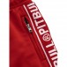 Tepláky PitBull v červené barvě s malým logem a nápisy pitbull na bocích.